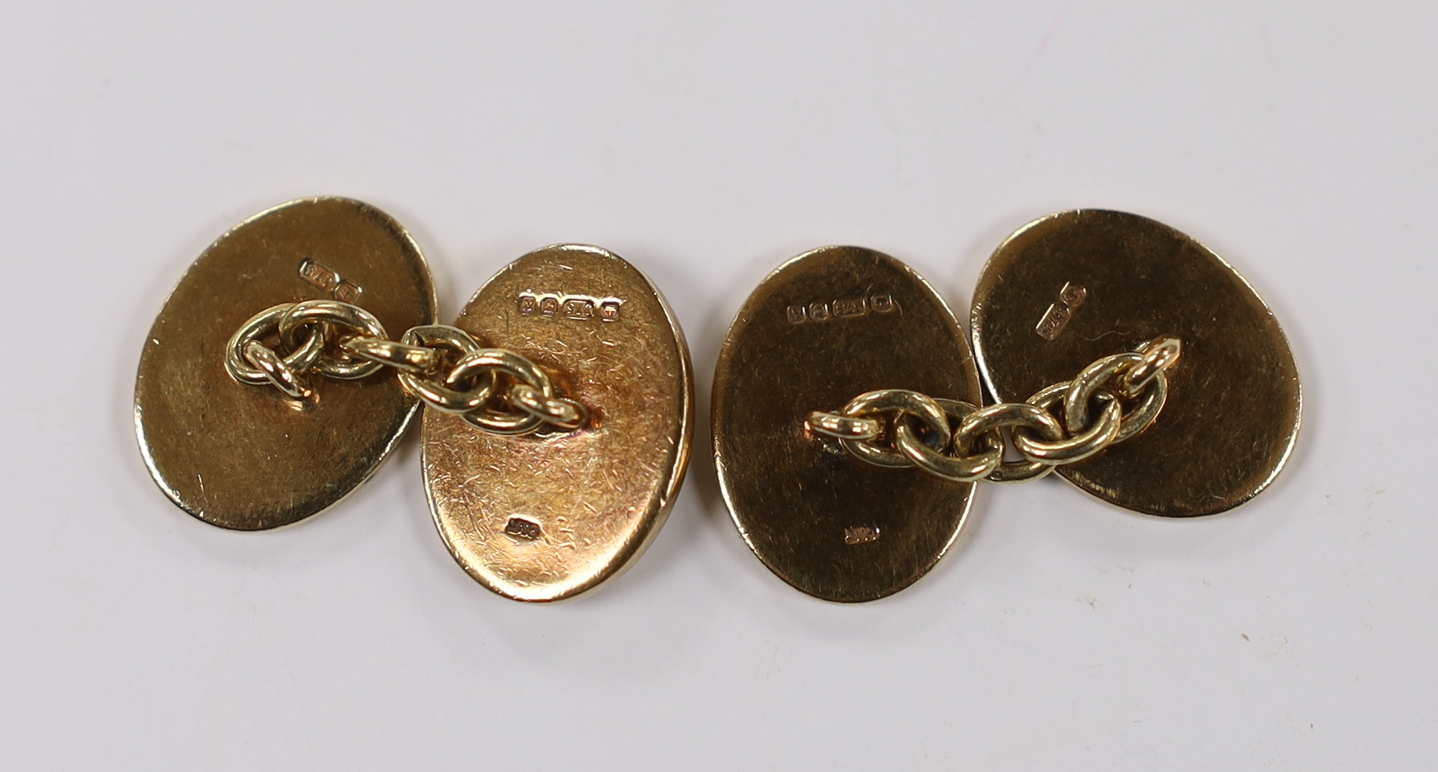 A pair of 1980's heavy 9ct gold oval cufflinks, with engraved crests, 16.2 grams.